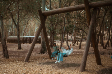 Savoring joyful moments while swinging in a peaceful forest surrounded by the beauty of natures tranquility