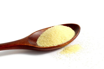 There is a wooden spoon with semolina on a white background.