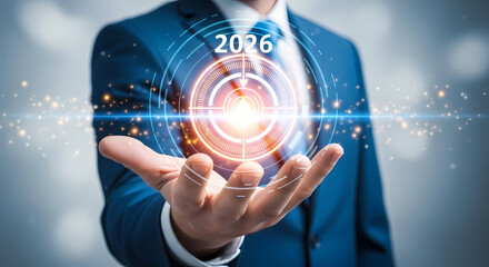 Businessman presenting a glowing 2026 target with futuristic interface on his hand