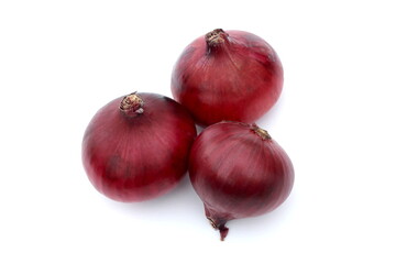 There are many purple onions lying on a white background.