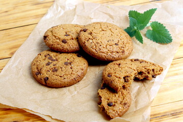 There are oatmeal cookies on the wooden table.	