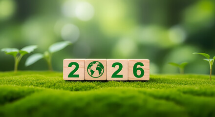 Eco friendly 2026 wooden blocks on green grass with sprouting plants background