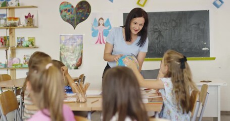 Teacher and elementary students learning geography with globe in classroom, curious children exploring world map together, social studies and global education for kids. - Powered by Adobe