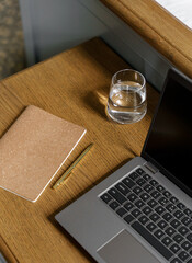 Cozy home office aesthetic with warm brown table and laptop