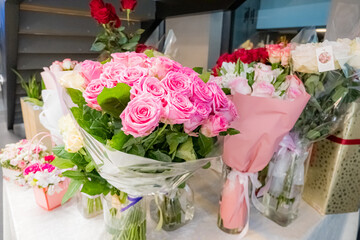 Vibrant bouquets of pink and red roses arranged beautifully in a flower shop, inviting visitors