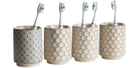 Four toothbrush holders with toothbrushes isolated on a transparent background ceramic