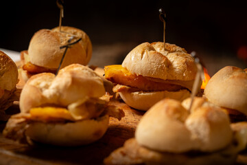 Macro close-up of a traditional pork leg sandwich with Serra cheese and grilled pineapple on rustic bread.