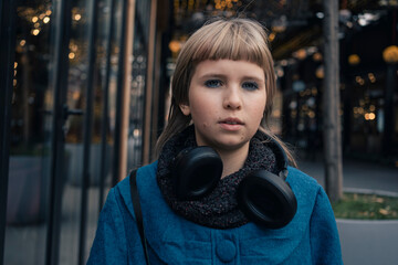Teen age girl walking in festive snowless city decorated for Christmas