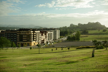 View of the La Florida district in Oviedo in soft afternoon light with green lawns of a city park 