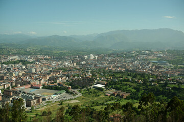 Naklejka premium Oviedo city view from Monte Naranco on a sunny day. Cityscape seen from the mountain