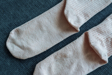 two old worn socks, one cleaned of pilling, the other not