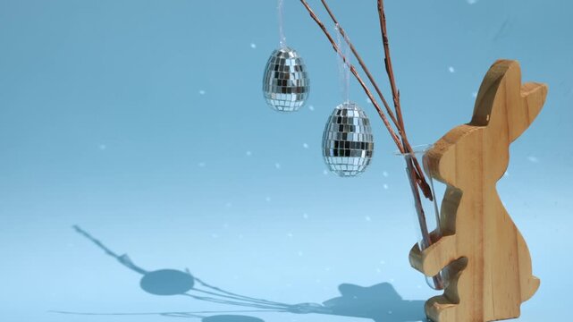 Creative easter setup with wooden bunny and disco eggs