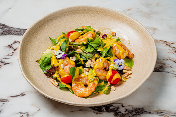 A tasty salad featuring succulent shrimp, fresh greens, and bright toppings bursting with flavor
