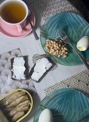 Fennel tea, hard-boiled egg, beans with tomato sauce, toast spread with soft cheese and sprats, dinner in the dark after the lights go out
