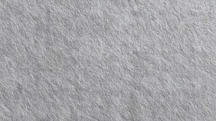 A close-up view of textured grey stone, showcasing its intricate patterns. The image emphasizes the natural variations and rough surface of the material