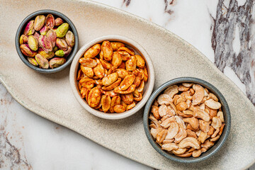 A beautiful platter holds roasted pistachios, spiced pumpkin seeds, and cashews