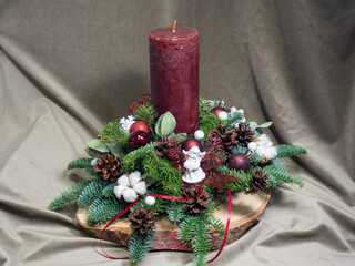 Christmas table decoration with red candle and white angel. Christmas greeting card. Advent wreath design