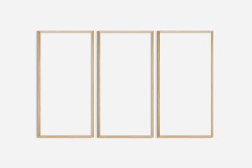 Frame mockup 1:2. Set of three thin cherry wood frames. Gallery wall mockup, set of 3 frames. Clean, modern, minimalist, bright. Portrait. Vertical.
