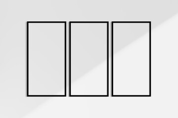 Frame mockup 1:2. Set of three thin black frames. Gallery wall mockup, set of 3 frames. Clean, modern, minimalist, bright. Portrait. Vertical. Shadow overlay.
