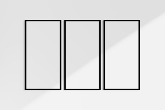 Frame mockup 1:2. Set of three thin black frames. Gallery wall mockup, set of 3 frames. Clean, modern, minimalist, bright. Portrait. Vertical. Shadow overlay.