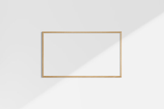 Horizontal frame mockup 16:9, 9:16 landscape. Single oak wood frame mockup. Clean, modern, minimalist, bright. Shadow overlay.