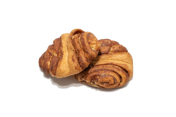 Two cinnamon rolls are stacked together on a white background, showing their layered structure. The warm tones and flaky texture create a classic bakery presentation.