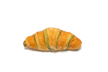 A croissant with green filling stripes is centered on a white background. The flaky layers and colored interior suggest a pistachio-flavored pastry.
