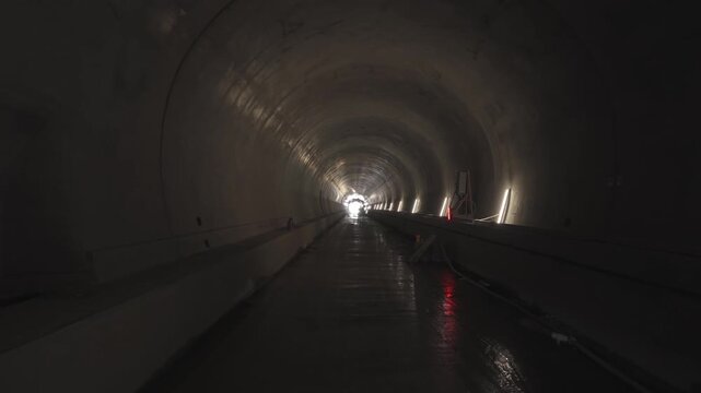 Highway tunnel 4k video. The interior of the first highway tunnel on the A1 Motorway near Curtea de Argeș during the final construction phase, showing the long, arched passage.