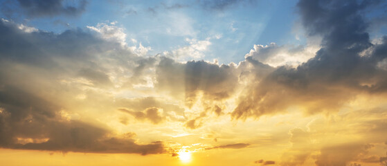 Dramatic sky with clouds and golden sunlight at sunset. Natural background showing peaceful evening atmosphere, hope and inspiration. Ideal for nature, weather and spirituality.