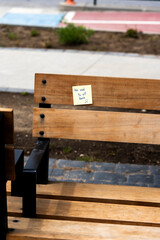 Concept of Loss and Past Relationships: Sticky Note on an Empty Wooden Seat