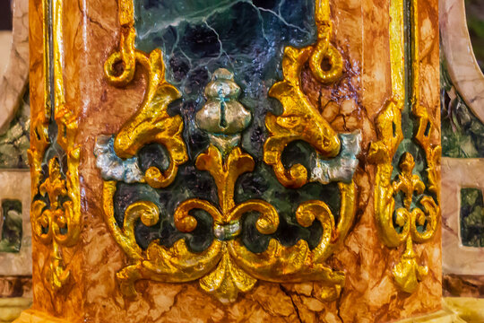 Ornate Gold-Decorated Marble Column With Intricate Filigree and Relief Artwork