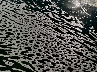 abstract pattern with waves of green water and white foam
