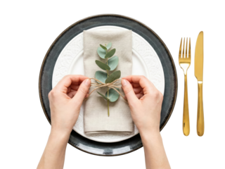 Elegant table setting with minimalist white and gold cutlery and natural green decor isolated on