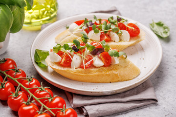 Tasty antipasto toasts featuring classic caprese with mozzarella and tomatoes, and savory prosciutto with herbs