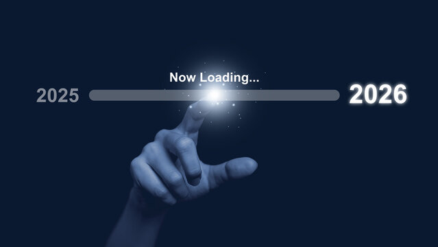 Human hand touch progress bar labeled now loading from 2025 to 2026 on dark background, symbolizing future transition, digital progress, new year change, innovation, technology advancement concept.