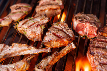 Juicy steaks and bell peppers sizzling on a grill