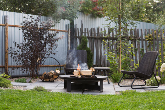 outside patio garden a Fire pit area with chairs. A cozy corner in a country house. an atmospheric relaxation area for evening gatherings by the fire