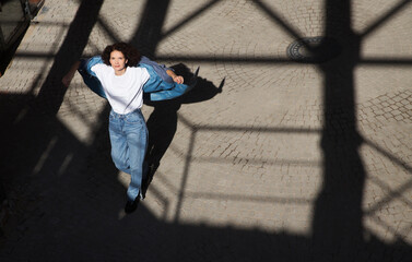 middle aged woman walks on the street of the  city. copy space. Slow life. Enjoying the little things. spends time in nature in summer