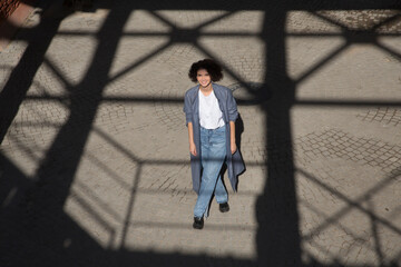 middle aged woman walks on the street of the  city. copy space. Slow life. Enjoying the little things. spends time in nature in summer