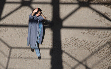 middle aged woman walks on the street of the  city. copy space. Slow life. Enjoying the little things. spends time in nature in summer