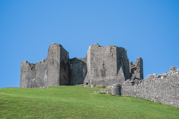 The ruin of Carreg Cennen Castle sited on a high rocky outcrop in Carmarthenshire, Wales on a sunny day
