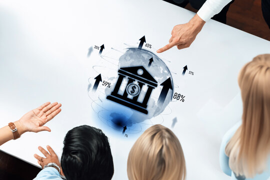 A diverse group of professionals is engaged in a business meeting, analyzing financial data displayed on a digital tablet. The image highlights upward growth trends and collaboration. Trope - Powered by Adobe