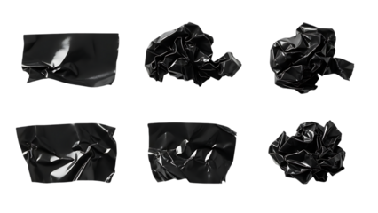 Wrinkled shiny black plastic fragments and crumpled balls isolated on a black background