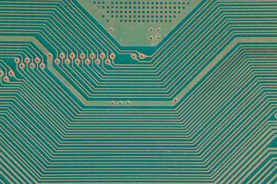 Macro of parallel copper lines on PCB, forming geometric network of tracks and vias, minimalistic high tech texture ideal for technology and connectivity concepts.