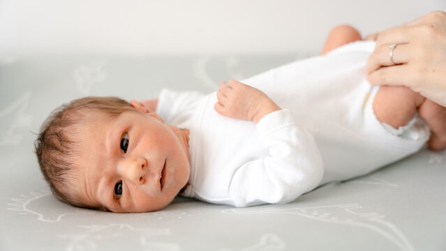 Newborn baby lying on back at home