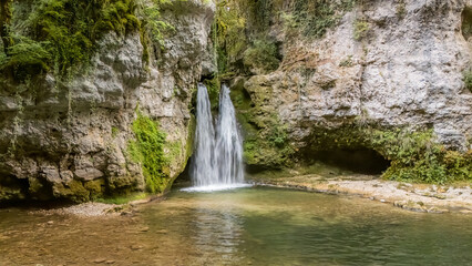 Serene waterfall flowing into a tranquil pool