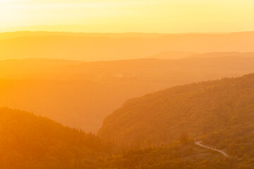 Scenic landscape of hills under a golden sunset glow