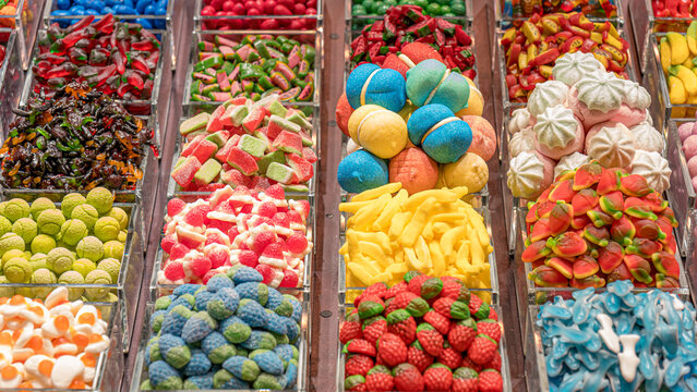 Assortment of colorful candies in transparent containers