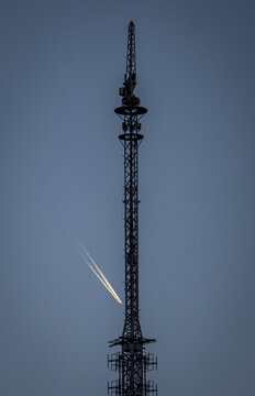 Nightfall over Tibidabo with distant contrail in dusk sky