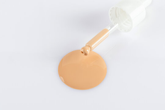 Liquid foundation sample with dropper on white background